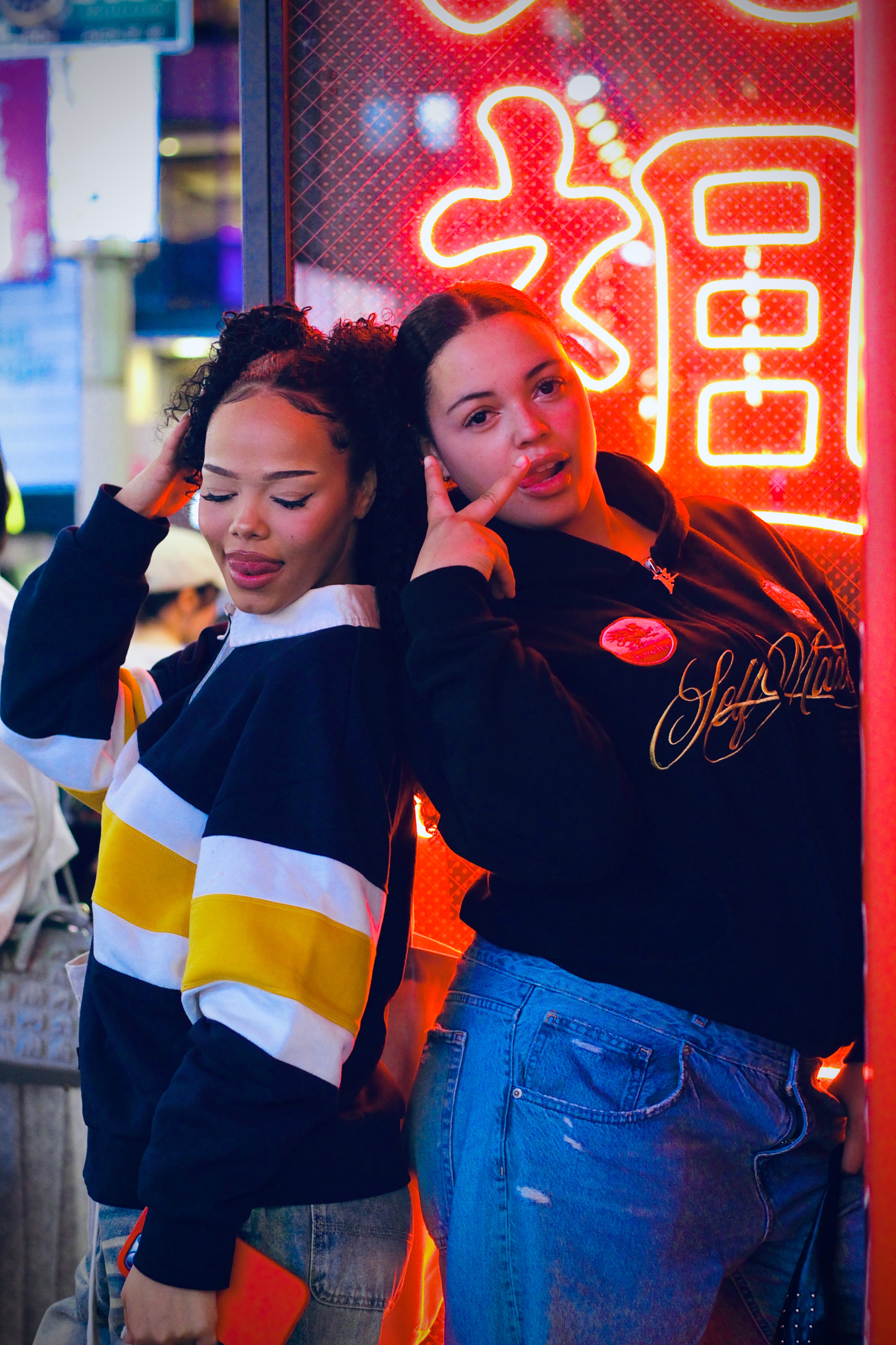 Editorial portrait against Shinjuku neon storefronts